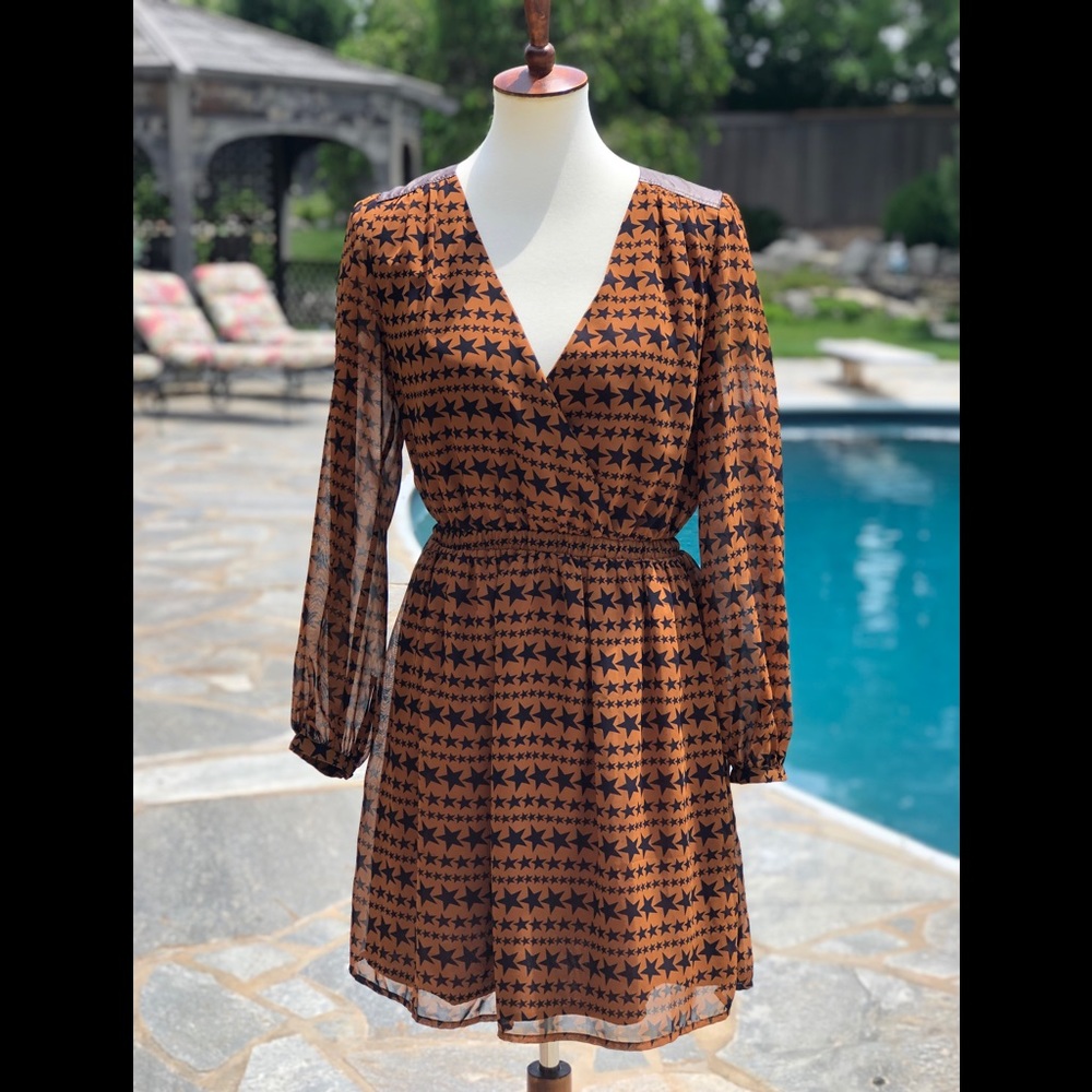 Skies are blue S brown and black stars dress